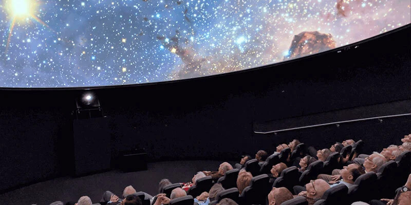 Visitors watching a presentation inside the ICR planetarium