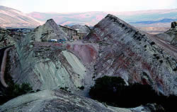 The Quarry Visitor Center perched upon steeply dipping Morrison Formation strata.  Photo by Bill Hoesch.